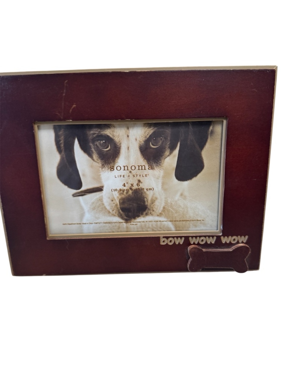 A Sonoma Life & Style brown wood picture frame with dog bone and bow wow wow